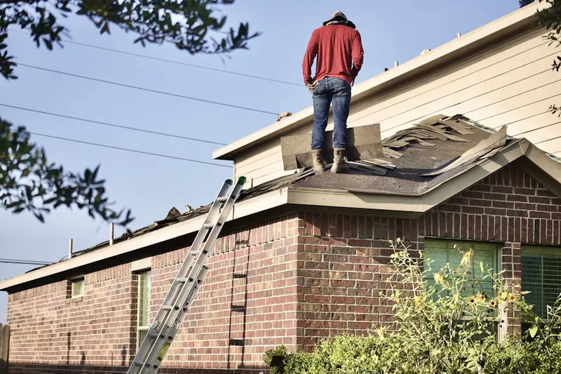 Professional roofer working on a residential roof in Mid-Town Belvedere